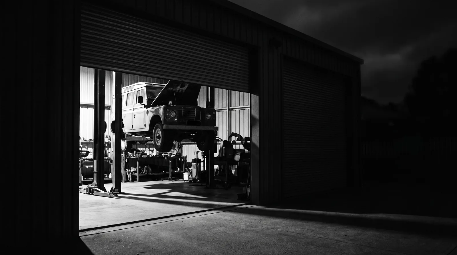 Engine workshop lit at night, illustrating after-hours engine work