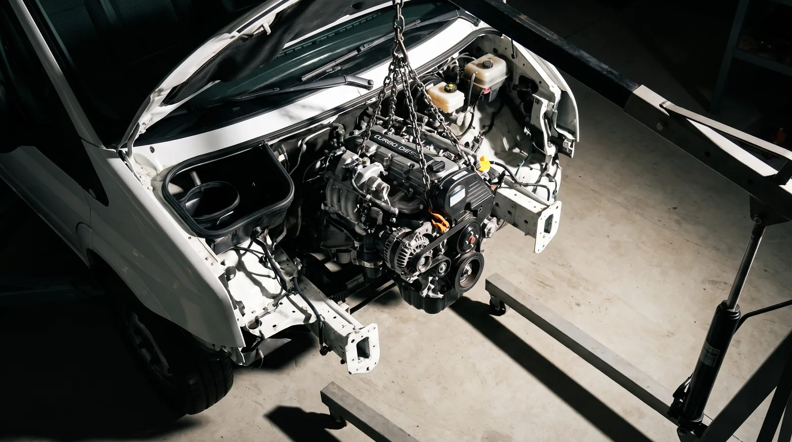 Reconditioned turbo diesel engine being lowered into a commercial van