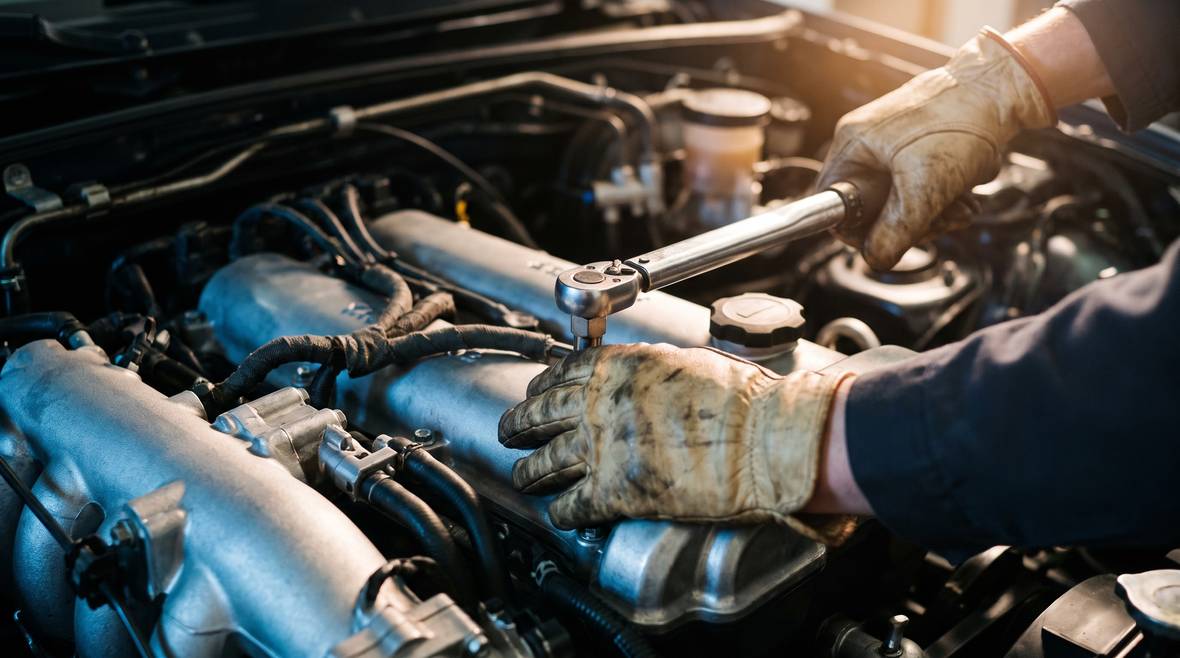 Technician torquing cylinder head bolts on a freshly fitted reconditioned engine
